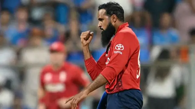 England's Adil Rashid celebrates after taking the wicket of India's Ishan Kishan