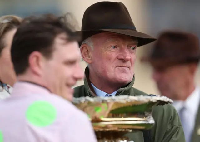 Winning jockey Paul Townend hold the trophy with trainer Willy Mullins
