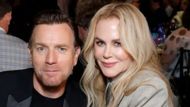 Ewan McGregor and Nicole Kidman in smart jackets, they are sitting shoulder to shoulder and smiling