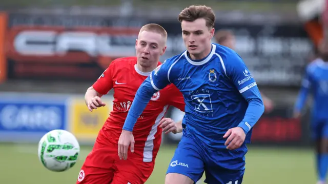 Dungannon Swifts' Adam Glenny challenges Conor McKendry of Larne