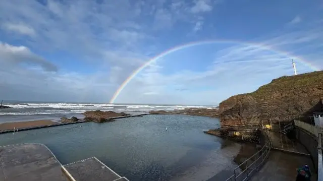 Rainbow over a sea pool