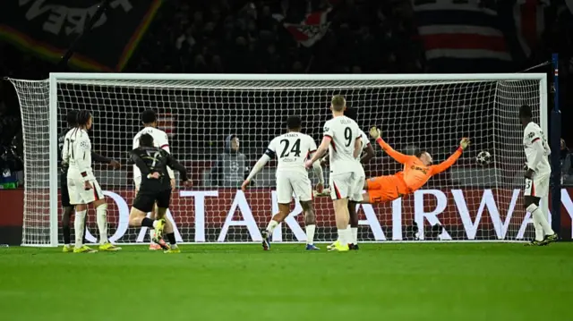 Paris Saint-Germain's Georgian forward #07 Khvicha Kvaratskhelia (Front L) scores his side's fourth goal past Chelsea's Danish goalkeeper #12 Filip Jorgensen.