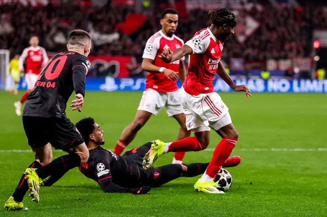 Noni Madueke of Arsenal is fouled by Malik Tillman of Bayer 04 Leverkusen for a penalty kick during the UEFA Champions League 2025/26 Round of 16 First Leg match between Bayer 04 Leverkusen and Arsenal FC at BayArena on March 11, 2026 in Leverkusen, Germany.