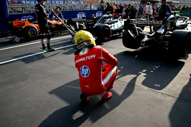 Lewis Hamilton looks at the rear of the Mercedes after sprint qualifying