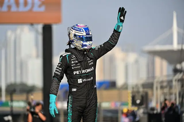George Russell waves to the crowd in Shanghai