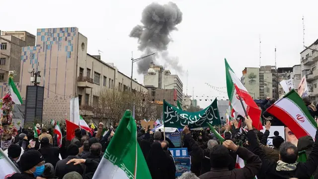 Smoke rises after an explosion during the march in Tehran