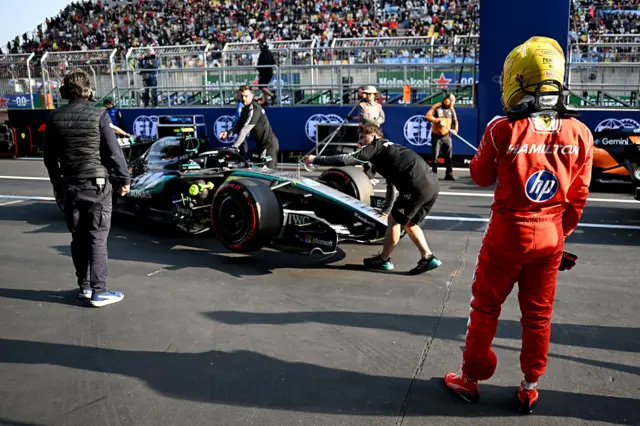 Lewis Hamilton looks at the Mercedes after qualifying