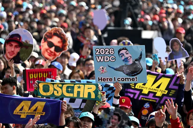 Fans hold up signs in Shanghai