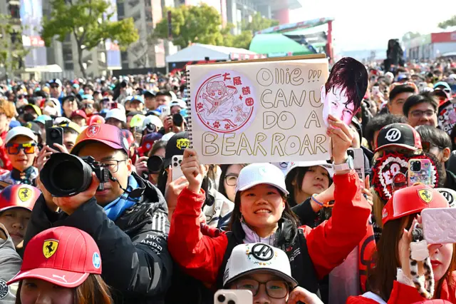Fans in China hold up sings