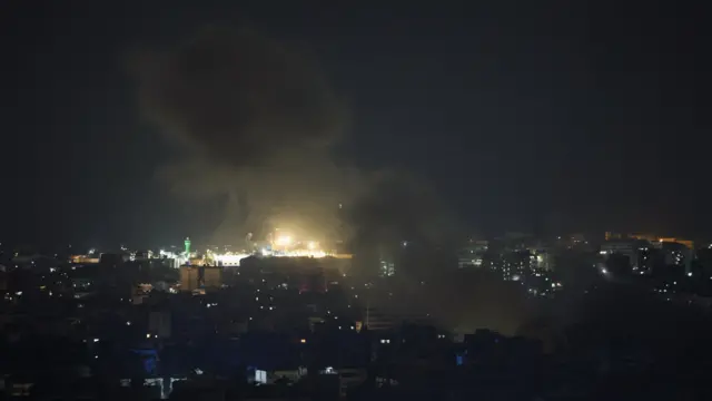 Smoke rises in large plumes over Beirut at night