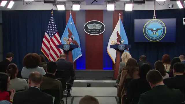 A screenshot from the Pentagon briefing room. Two lecterns are positioned next to one another