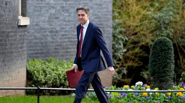 Ed Miliband pictured on Downing Street holding a folder