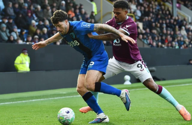 AFC Bournemouth's Marcos Senesi in action with Burnley's Lyle Foster