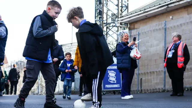 Birmingham fans have a kickabout outside St Andrew's