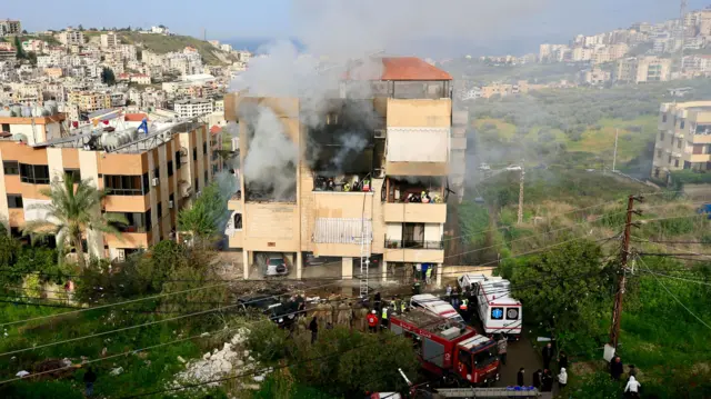 Rescuers work at a building after an Israeli airstrike hit the Haret Saida area of Sidon, southern Lebanon