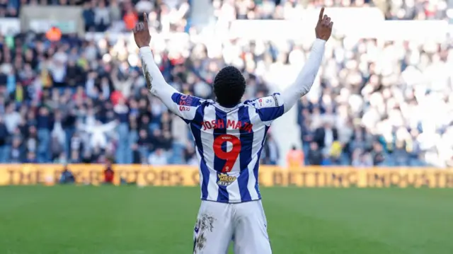 Josh Maja points to the sky with both hands after scoring