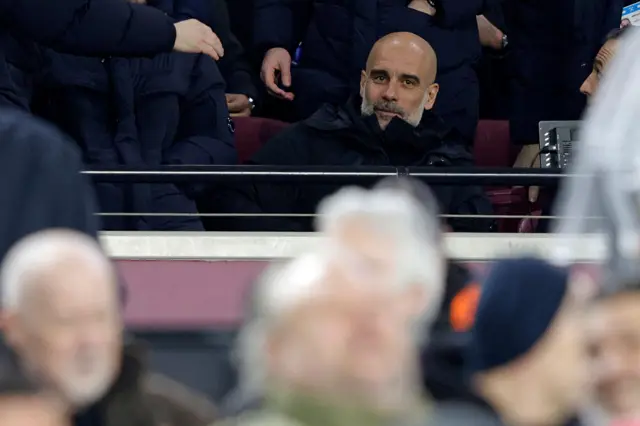 Manchester City manager Pep Guardiola watching the game from the stands