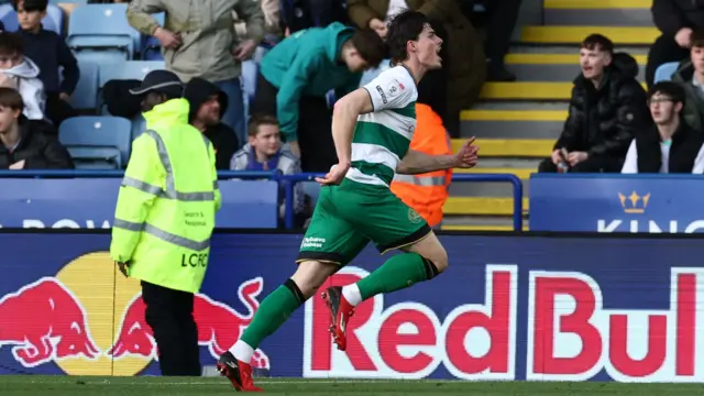 QPR's Ronnie Edwards runs off to celebrate after scoring at Leicester