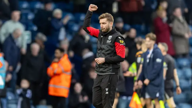 West Brom interim head coach James Morrison raises a fist in celebration