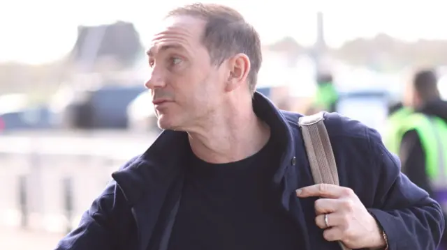 Coventry boss Frank Lampard greeting fans while arriving to the CBS Arena before kick-off against Southampton while holding a bag over his left shoulder.