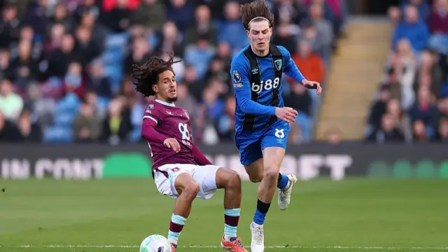 Alex Scott is challenged by Hannibal Mejbri