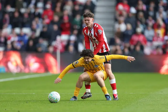 Ferdi Kadioglu of Brighton & Hove Albion is put under pressure by Chris Rigg