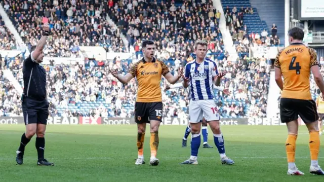 Hull's Charlie Hughes is shown a red card