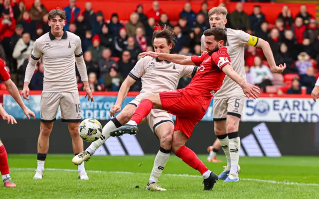 Graeme Shinnie goes for goal