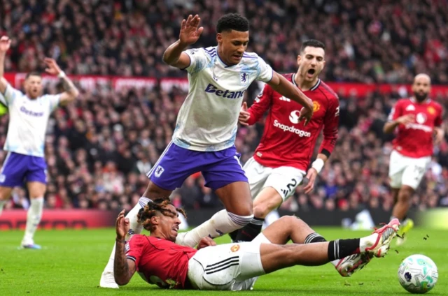 Manchester United's Leny Yoro (left) and Aston Villa's Ollie Watkins battle for the ball