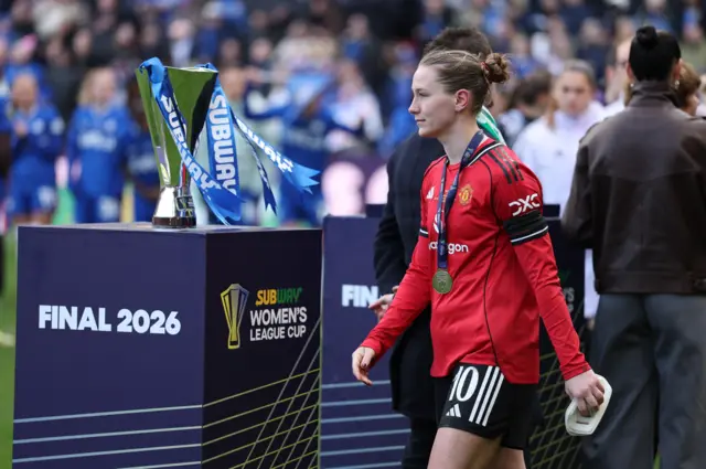 Terland walks past the trophy