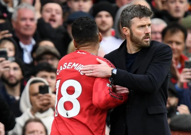Manchester United interim manager Michael Carrick shakes hands with Casemiro a
