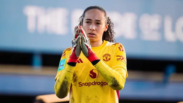 Phallon Tullis-Joyce of Manchester United applauds fans.