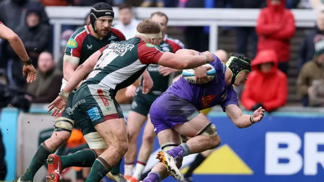 Ross Vintcent (right) ducks and runs with the ball under his right arm