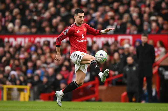 Diogo Dalot controls the ball