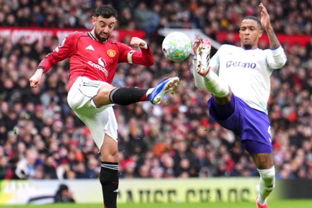 Manchester United's Bruno Fernandes (left) and Aston Villa's Ezri Konsa battle for the ball