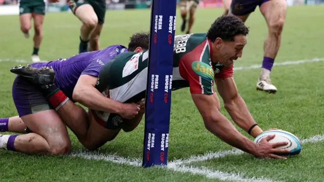 Gabriel Hamer-Webb touches the ball down over the line under a tackle