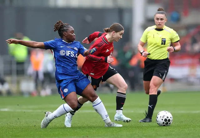 Jess Park of Manchester United is challenged by Sandy Baltimore of Chelsea