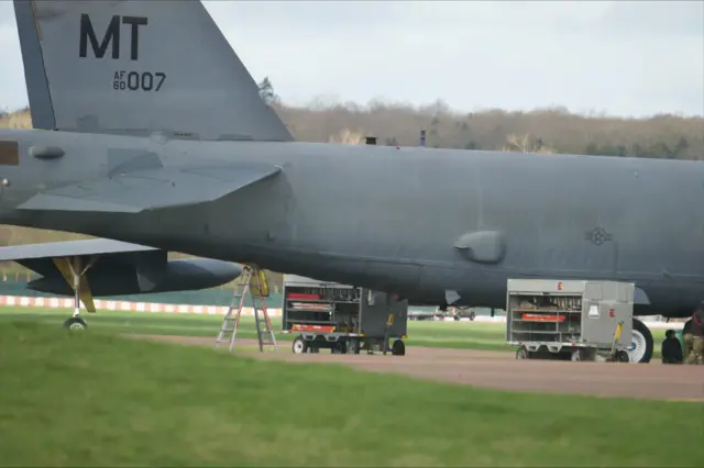Bombs are seen on racks towards the back of a USAF B-52 bomber