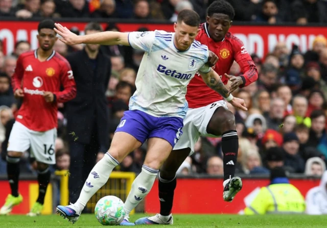 Aston Villa's Ross Barkley in action with Manchester United's Kobbie Mainoo
