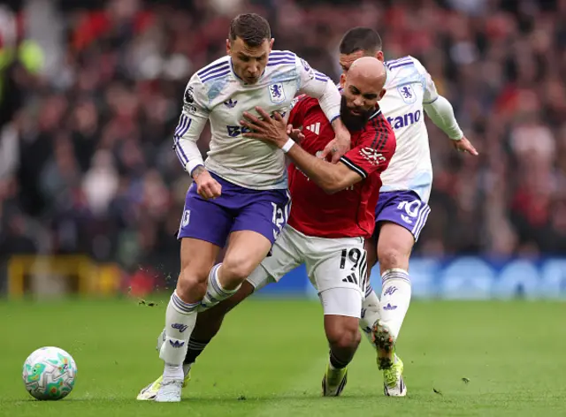 Bryan Mbeumo of Manchester United is challenged by Lucas Digne and Emi Buendia