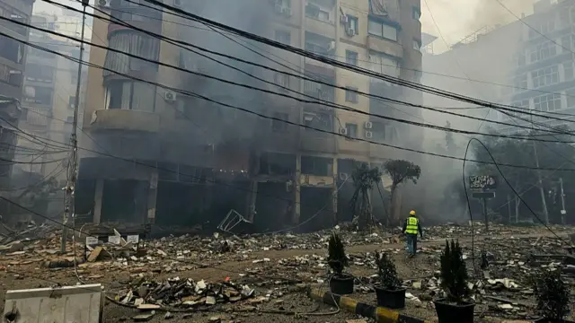 A rescuer arrives at the site of an Israeli airstrike on a residential blocks in Beirut's southern suburb of Haret Hreik on 15 March 2026.