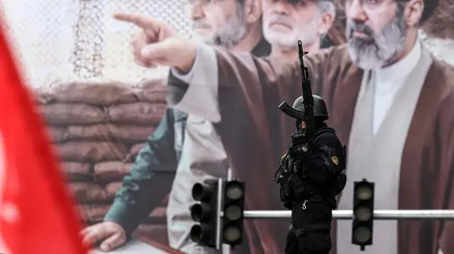 A man in black with a gun