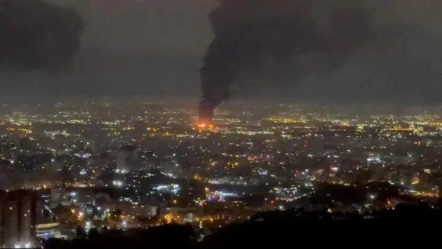 Smoke rises over city