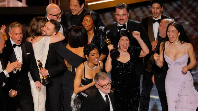 Director Paul Thomas Anderson and cast members celebrate as they accept the Oscar for Best Picture for "One Battle after Another".