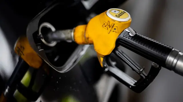 A close up image of a yellow petrol pump used to refill a car