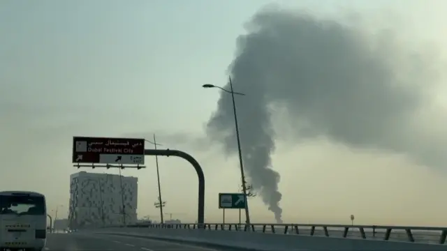 Plume of smoke is visible beside a roadway in Dubai.