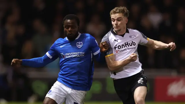 Portsmouth and Derby players challenge for the ball