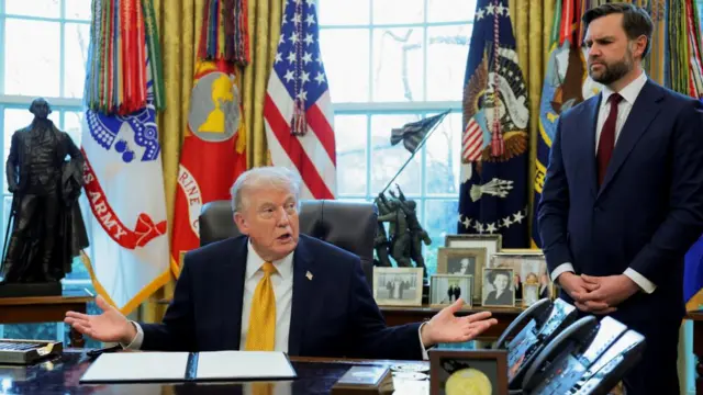President Donald Trump seated next to Vice-President JD Vance,  who is standing, speaks during an event in the Oval Office