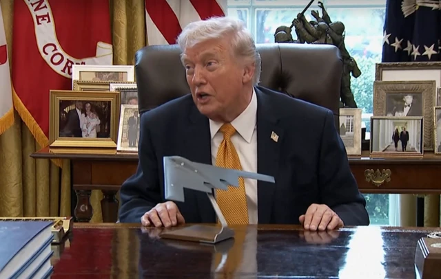 A model of B-2 bomber on the Resolute Desk as Trump speaks