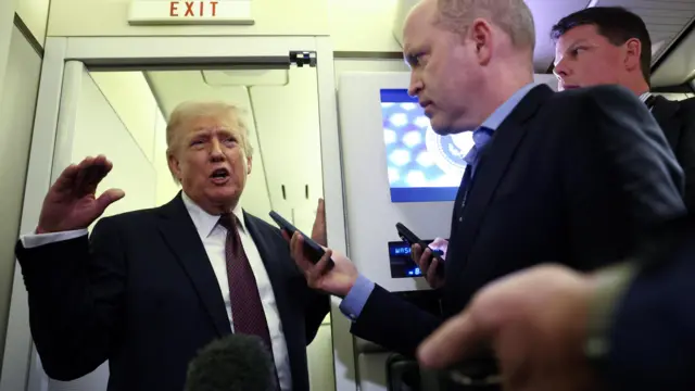 Trump speaks to reporters under an 